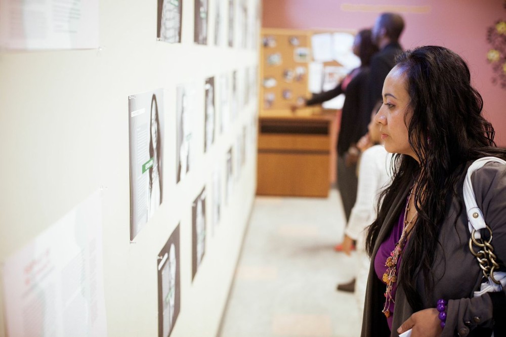 Women admires exhibit at Cook Library Center